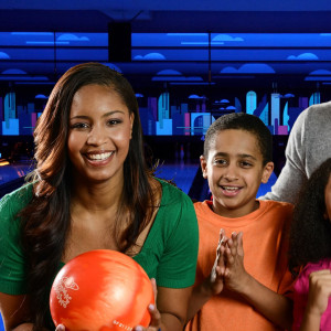 Family of four enjoying bowling