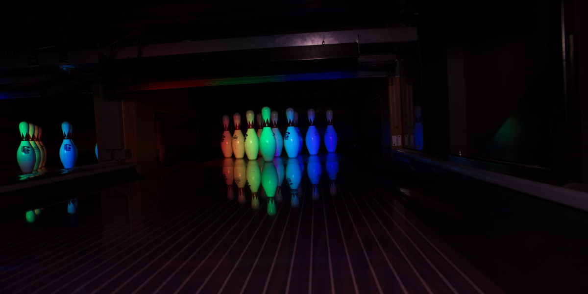 Bowling pins glowing under lasers and black lights