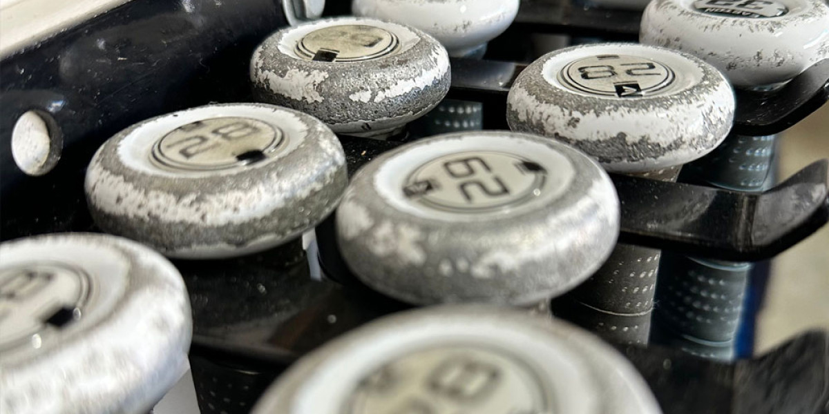 Close-up of worn golf club grips, each with a number 62 on top. The grips show visible signs of wear, with peeling and faded surfaces. Stacked together in a rack at Spare Time Texas, these clubs await players ready to switch from bowling lanes to the mini-golf course.