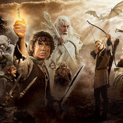 In a dramatic landscape, fantasy characters come to life as a figure holds a glowing object. An archer aims his bow, while a wizard stands ready among others wielding weapons. A dragon soars above, casting shadows reminiscent of the thrill found at Spare Time Texas's immersive family fun center.