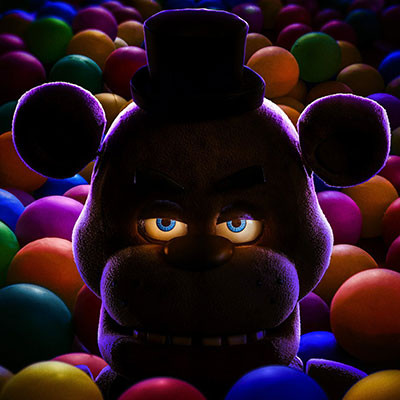 In a dimly lit setting at Spare Time Texas, a bear-like animatronic character with glowing blue eyes and a top hat is surrounded by colorful balls, creating the perfect backdrop for unforgettable family fun.