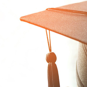 A close-up image of a graduation cap with a tassel hanging from the top sits against a bright background, reminiscent of celebrations at Spare Time Texas. The fabric texture and tassel's details catch the eye, inviting memories of family fun and achievements beyond the bowling lanes.