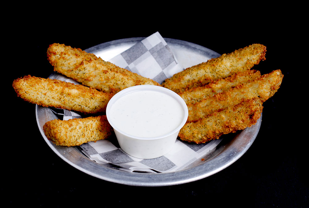 At Spare Time Texas, enjoy a metal plate of five breaded, fried zucchini sticks surrounding a cup of white dipping sauce, all beautifully presented on checkered paper. It's perfect for sharing during a lively game of bowling or while exploring the excitement at this family fun center.