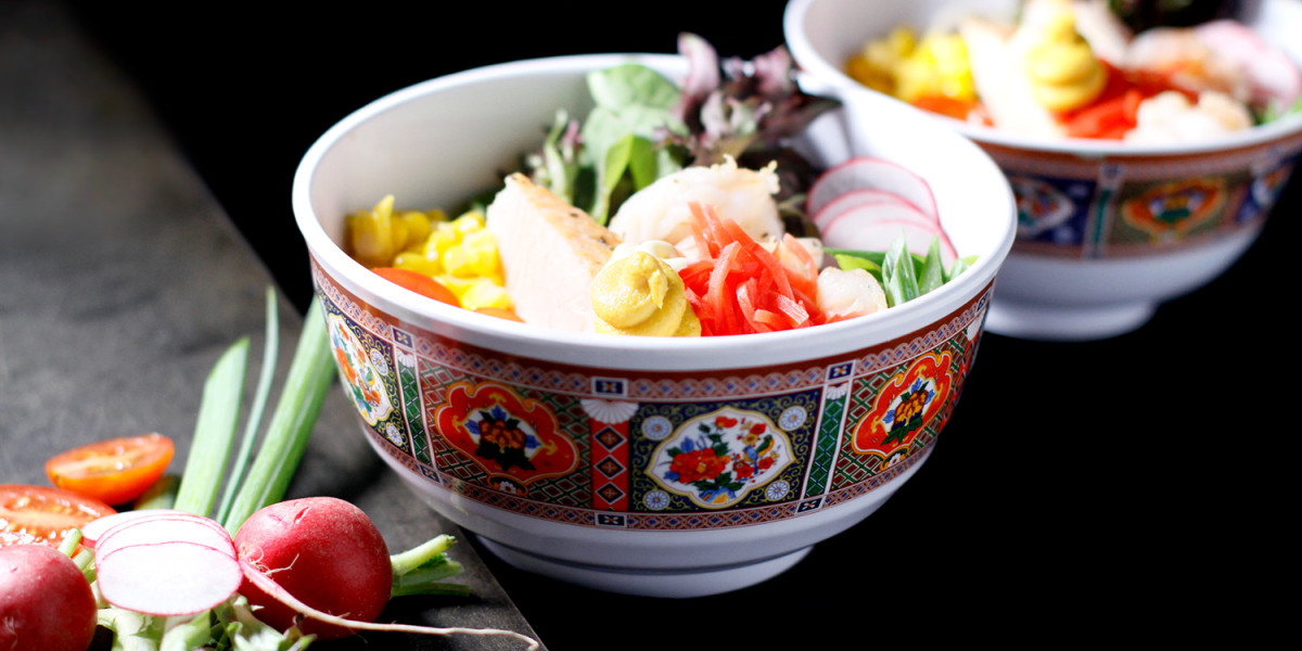 A colorful salad bowl featuring sliced radishes, cherry tomatoes, and lettuce sits invitingly as if ready for a healthy meal at Spare Time Texas—a family fun center that offers more than just bowling. In the background, a similar bowl teases with fresh ingredients on the table.