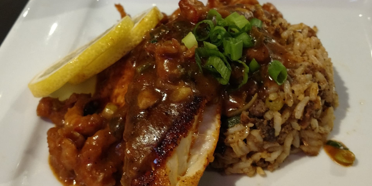 At Spare Time Texas, enjoy a delightful dish featuring seasoned fish topped with savory sauce and green onions. Complemented by vegetable-mixed rice and fresh lemon slices, it's the perfect treat after an exciting day at the family fun center or a competitive round of bowling.