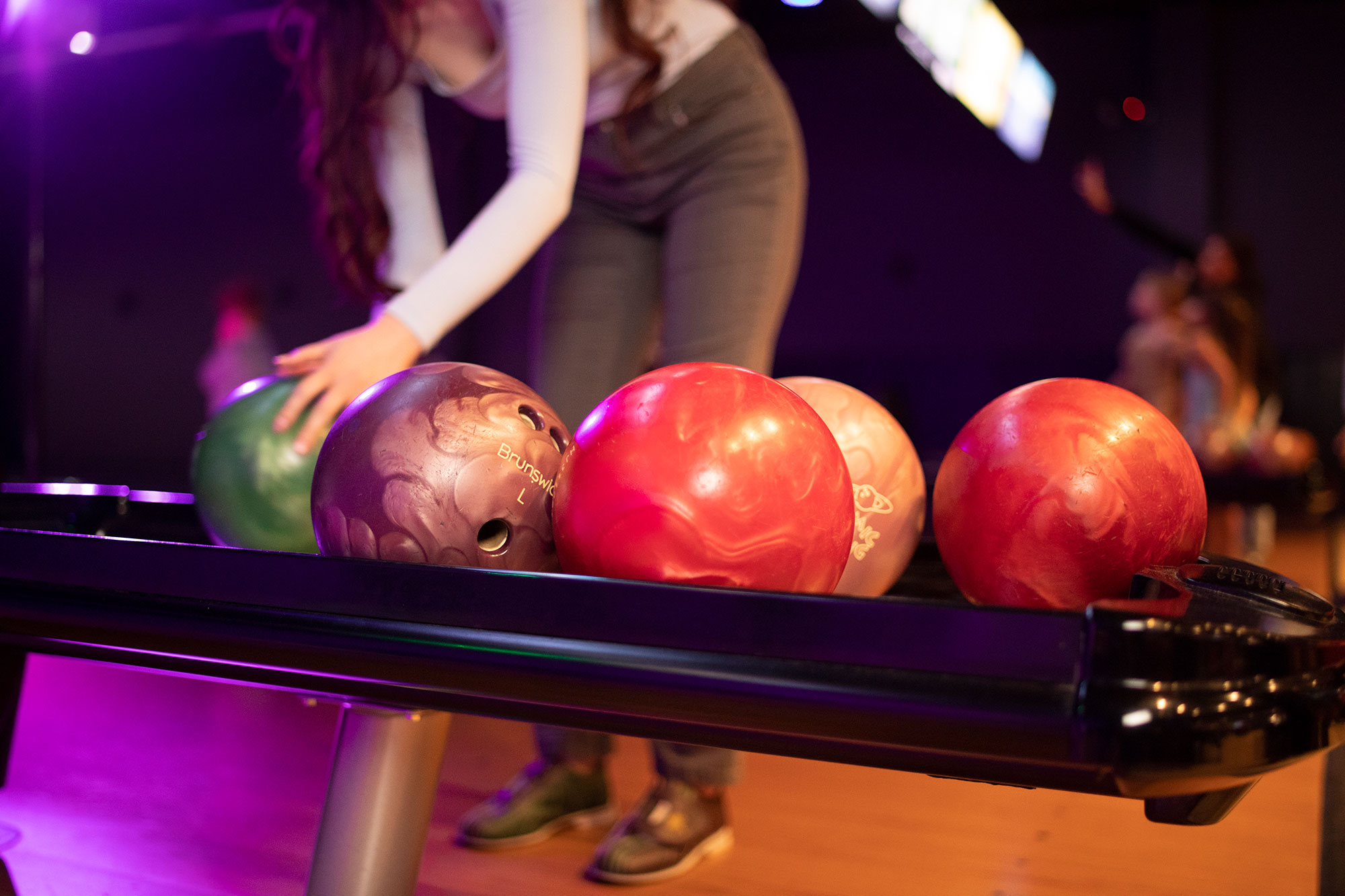 Young Woman Choosing Bowling Ball